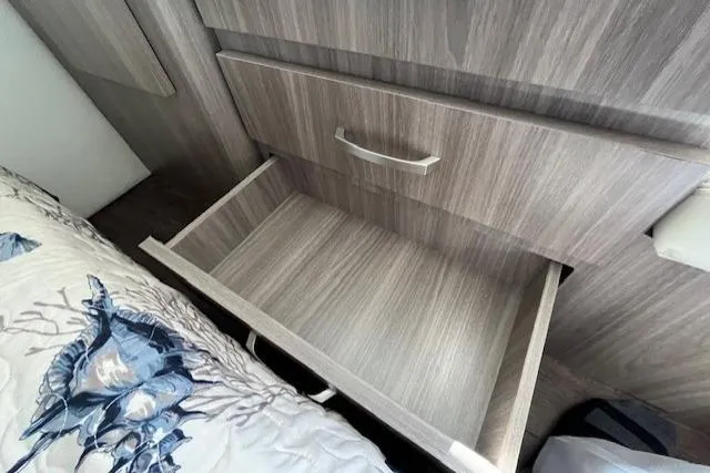 Slide: The Image of Empty wooden drawer in a 2022 Regal 38 XO boat interior. - 27