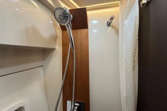 Slide: The Image of Shower area in 2022 Regal 38 XO yacht with modern fixtures and wood accents. - 32