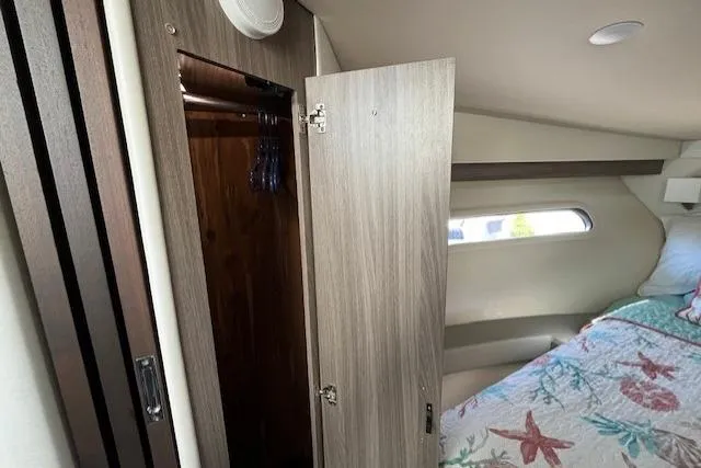 Slide: The Image of Interior cabin of 2022 Regal 38 XO yacht with open closet and bed. - 33