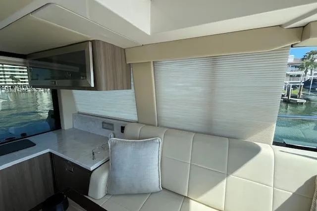 Slide: The Image of Interior of 2022 Regal 38 XO yacht with modern seating and window view. - 35