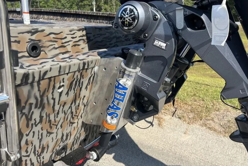 Slide: The Image of 2026 Xpress H20 boat with camo design and Atlas hydraulic jack plate. - 11