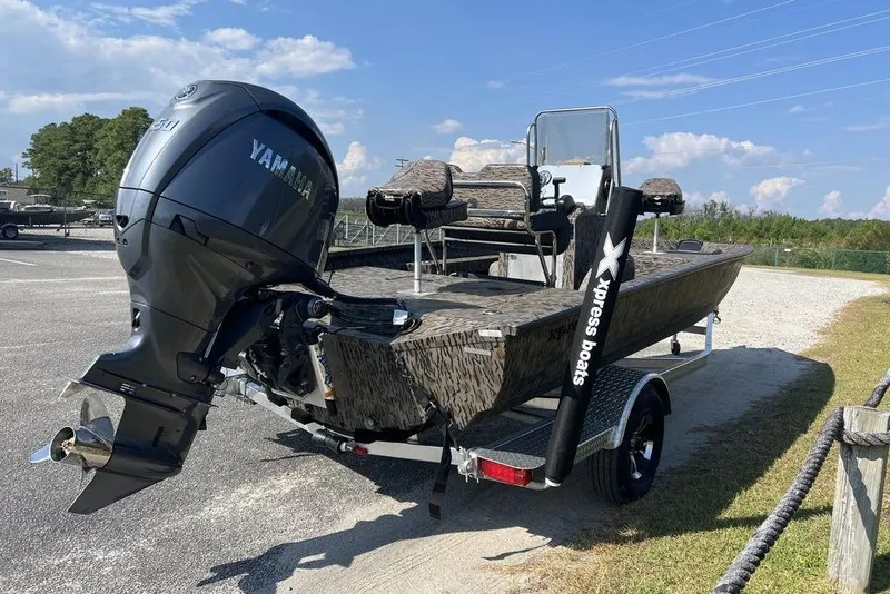 Slide: The Image of 2026 Xpress H20 boat with Yamaha engine, parked outdoors on a sunny day. - 6