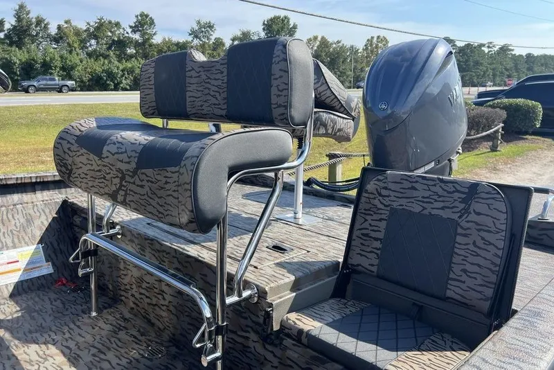 Slide: The Image of 2026 Xpress H20 boat interior with patterned seating and powerful outboard motor. - 7