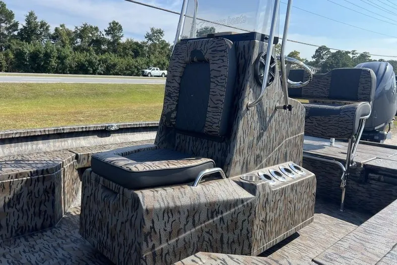 Slide: The Image of 2026 Xpress H20 boat interior with camouflage seating and console design. - 8