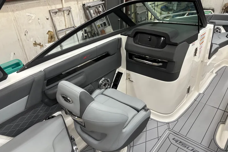 Slide: The Image of 2025 Chaparral 26 Surf boat interior with modern seating and dashboard design. - 12