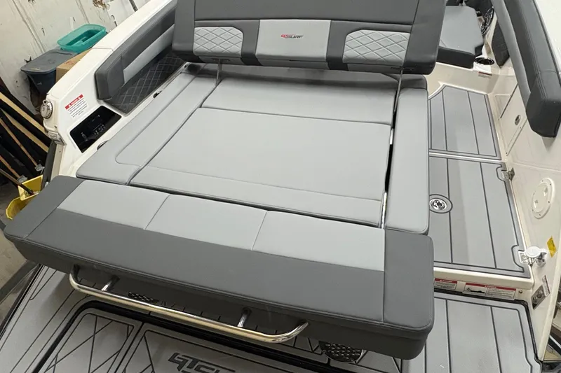 Slide: The Image of 2025 Chaparral 26 Surf boat interior with gray cushioned seating and sleek design. - 8