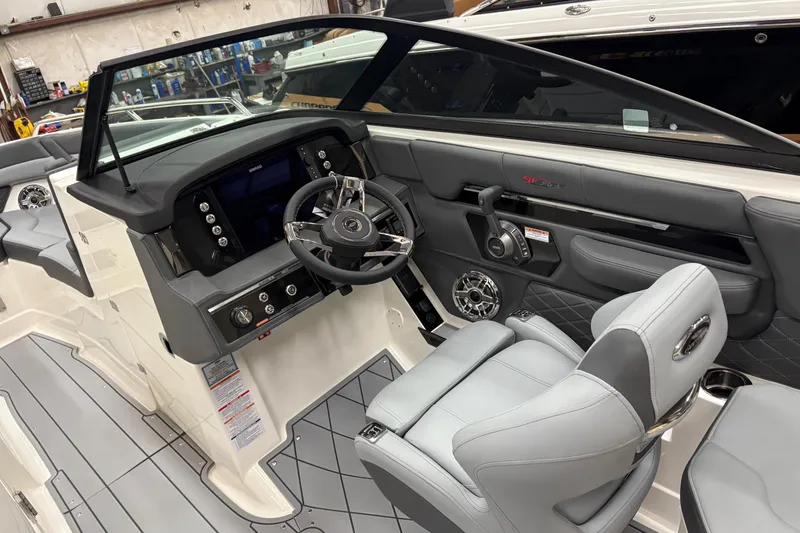 Slide: The Image of 2025 Chaparral 26 Surf boat interior with modern dashboard and steering wheel. - 9