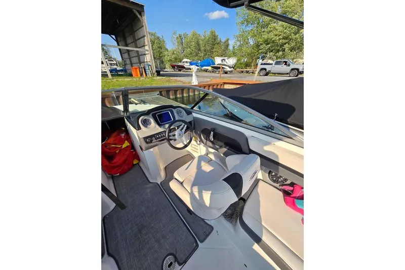 Slide: The Image of 2017 Chaparral Vortex 203 VR boat interior with steering wheel and dashboard. - 10