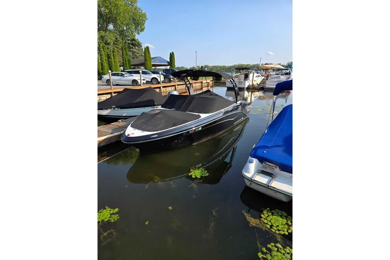 Slide: The Image of 2017 Chaparral Vortex 203 VR boat docked in a marina, covered and ready for use. - 4