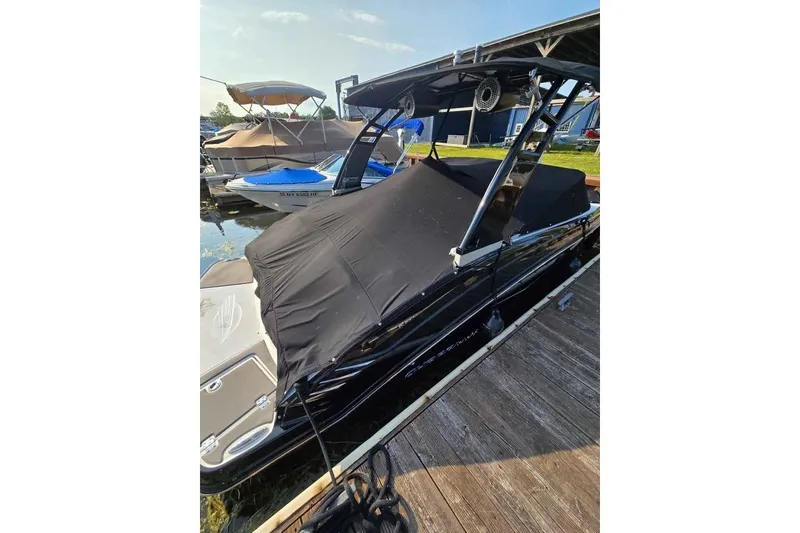 Slide: The Image of 2017 Chaparral Vortex 203 VR boat docked with black cover. - 5