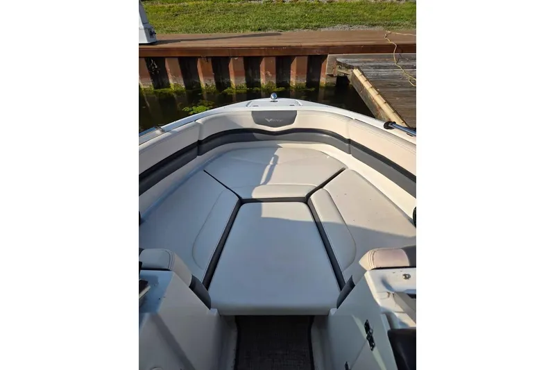 Slide: The Image of 2017 Chaparral Vortex 203 VR boat interior with cushioned seating at dock. - 8