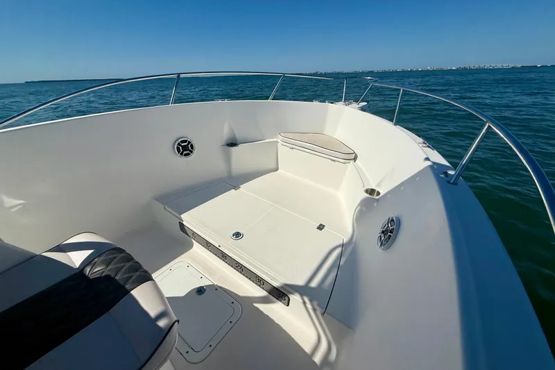 Slide: The Image of 2001 Aquasport 205 Osprey boat interior with seating, on calm blue water. - 11