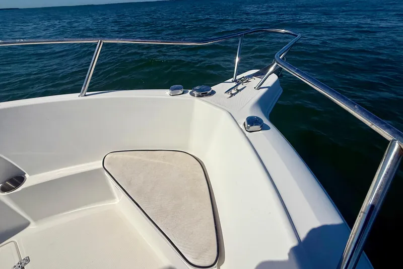 Slide: The Image of Bow of 2001 Aquasport 205 Osprey boat on open water, featuring stainless steel railings. - 12