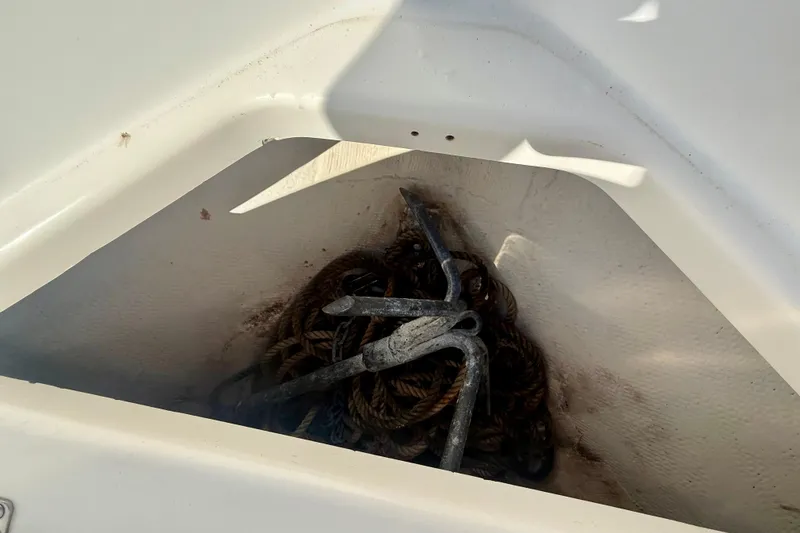 Slide: The Image of Anchor and rope storage in 2001 Aquasport 205 Osprey boat compartment. - 13