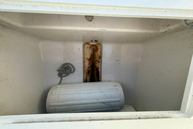 Slide: The Image of Storage compartment of 2001 Aquasport 205 Osprey boat with rope and fender. - 16
