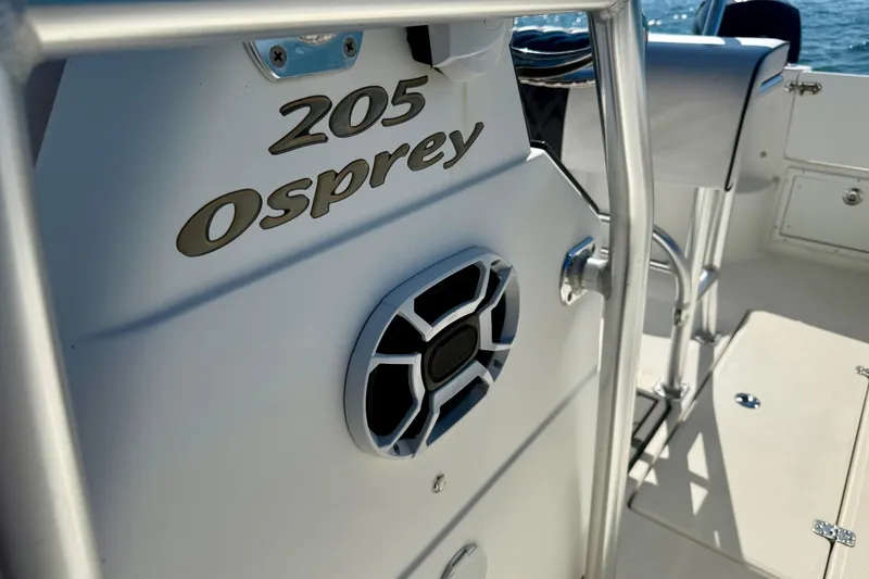 Slide: The Image of 2001 Aquasport 205 Osprey boat interior with speaker and railing details. - 18