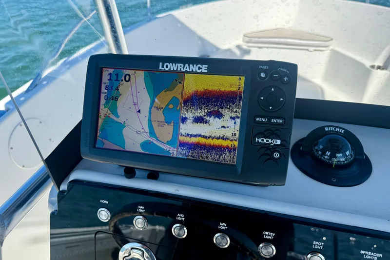 Slide: The Image of Lowrance fishfinder and compass on 2001 Aquasport 205 Osprey boat dashboard. - 21