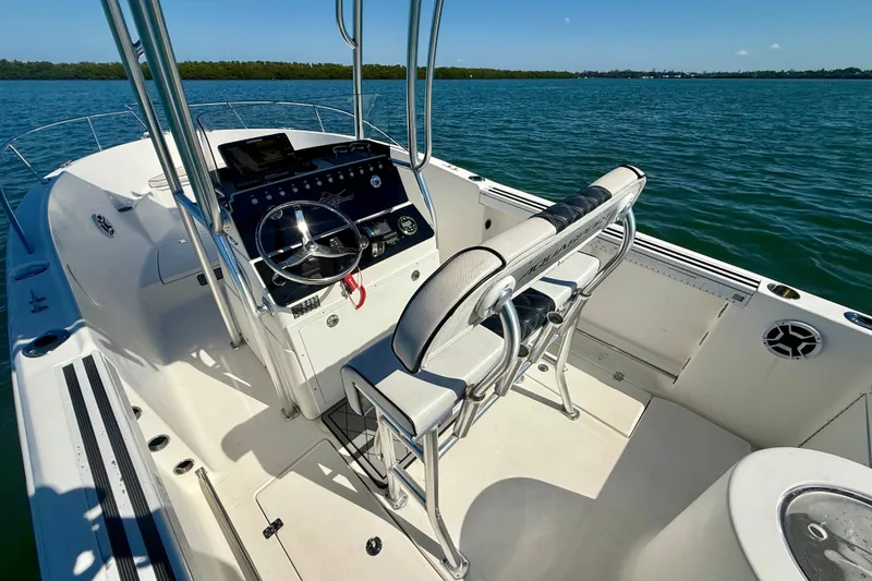 Slide: The Image of 2001 Aquasport 205 Osprey boat interior with steering console on calm water. - 29