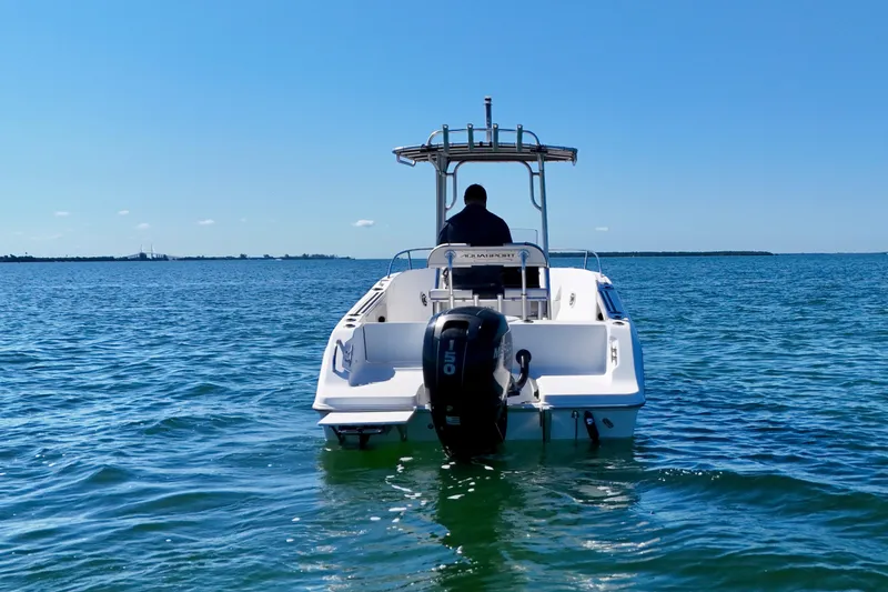Slide: The Image of 2001 Aquasport 205 Osprey boat on open water, rear view with outboard motor. - 8