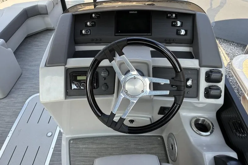 Slide: The Image of 2022 Bennington 22 LFB boat dashboard with steering wheel and control panel. - 4