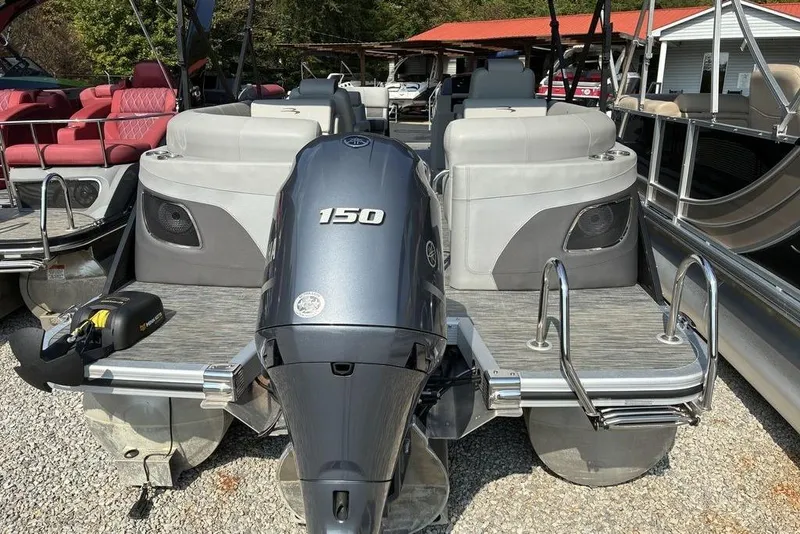 Slide: The Image of 2022 Bennington 22 LFB pontoon boat with 150 HP engine, docked outdoors. - 6
