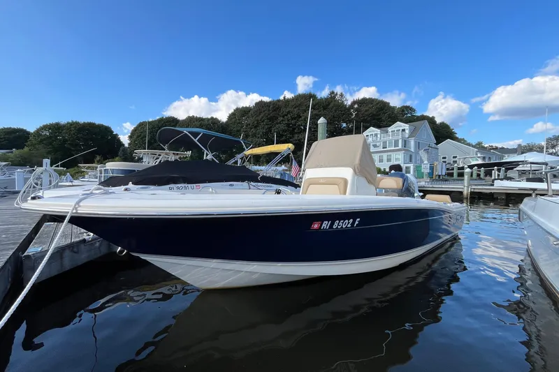Slide: The Image of 2020 Scout 195 Sportfish boat docked at marina under clear blue sky. - 0