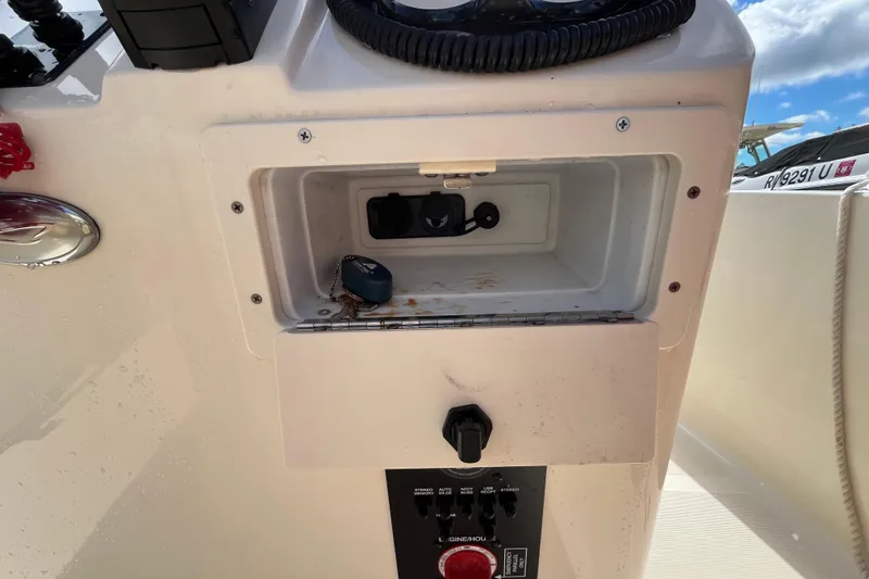 Slide: The Image of Control panel of a 2020 Scout 195 Sportfish boat with storage compartment. - 15