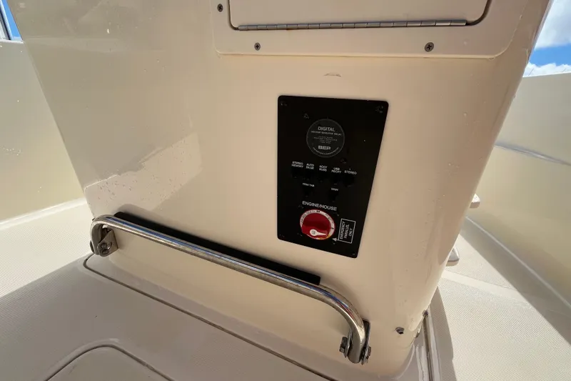 Slide: The Image of Control panel on 2020 Scout 195 Sportfish boat, featuring digital display and safety handle. - 16