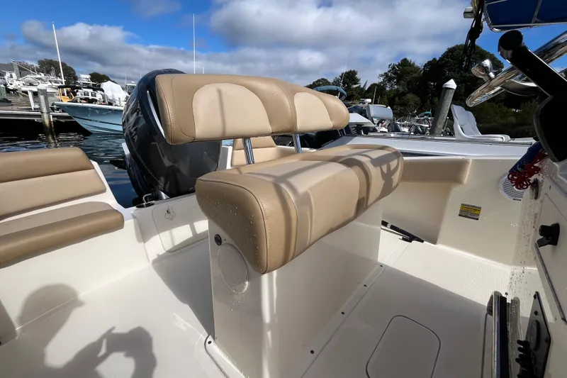 Slide: The Image of 2020 Scout 195 Sportfish boat interior with beige seating and steering console. - 17