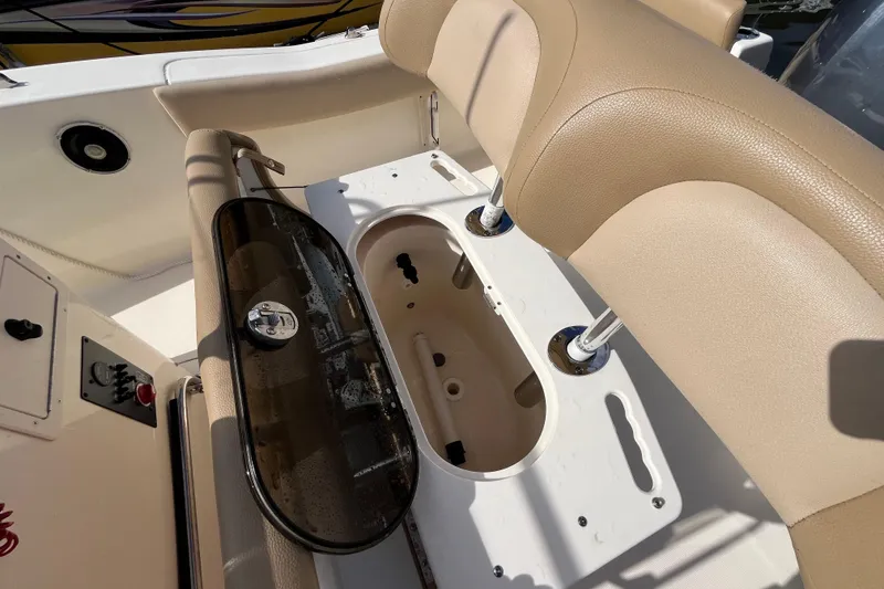 Slide: The Image of 2020 Scout 195 Sportfish boat interior with beige seating and storage compartment. - 20