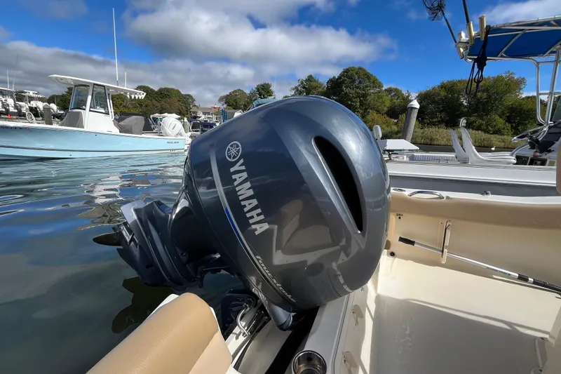 Slide: The Image of 2020 Scout 195 Sportfish with Yamaha outboard motor, docked on a sunny day. - 22
