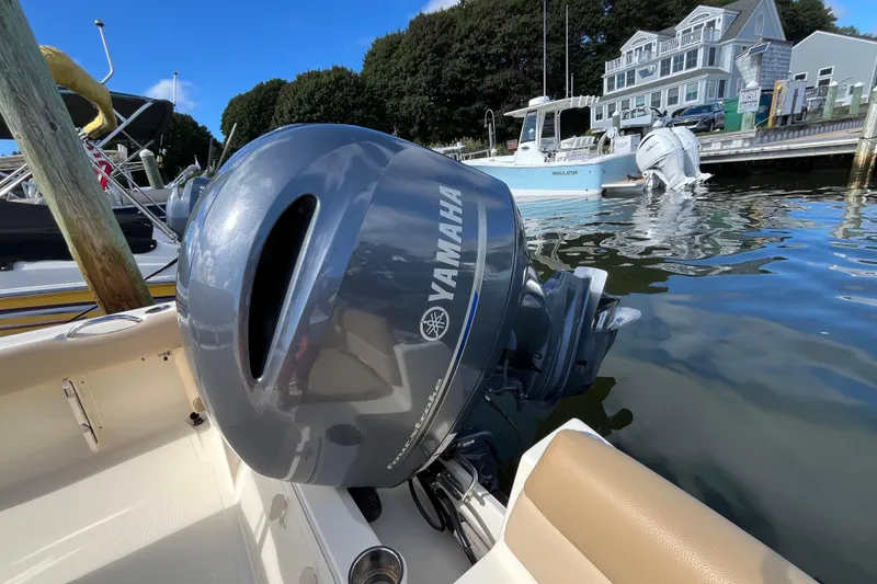 Slide: The Image of 2020 Scout 195 Sportfish with Yamaha outboard motor docked at marina. - 24