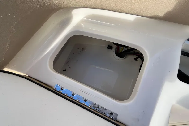 Slide: The Image of Open storage compartment on 2020 Scout 195 Sportfish boat, showing interior wiring. - 26
