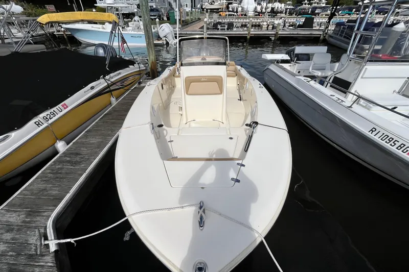 Slide: The Image of 2020 Scout 195 Sportfish boat docked at marina, surrounded by other vessels. - 3
