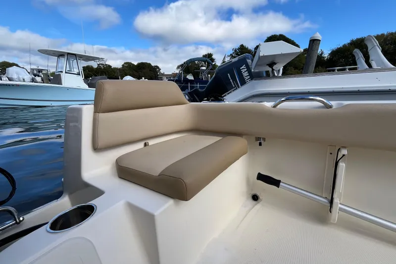 Slide: The Image of 2020 Scout 195 Sportfish boat interior with beige seating and Yamaha engine. - 30