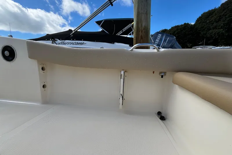 Slide: The Image of 2020 Scout 195 Sportfish boat interior with Yamaha engine, clear sky background. - 32