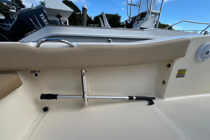 Slide: The Image of 2020 Scout 195 Sportfish boat interior with Yamaha engine, featuring a mounted boat hook. - 33