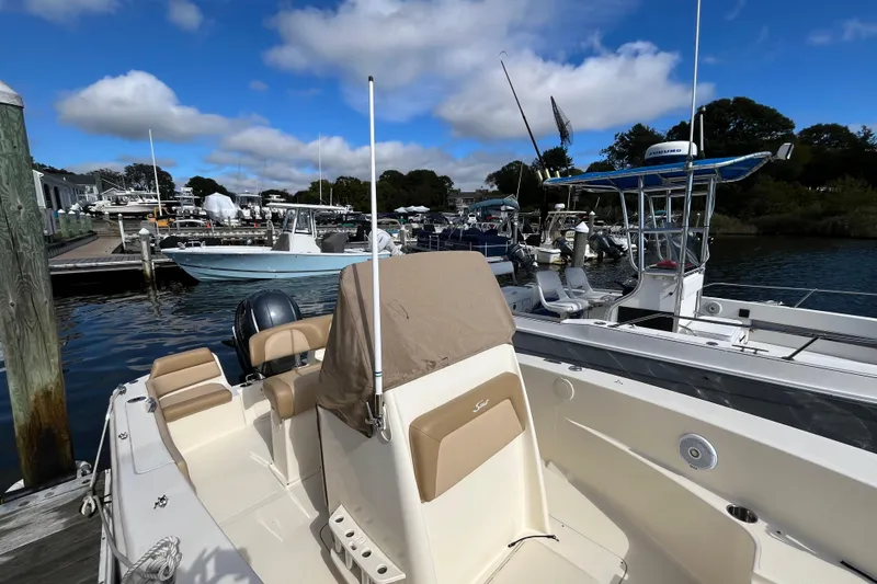 Slide: The Image of 2020 Scout 195 Sportfish boat docked at marina under blue sky. - 37