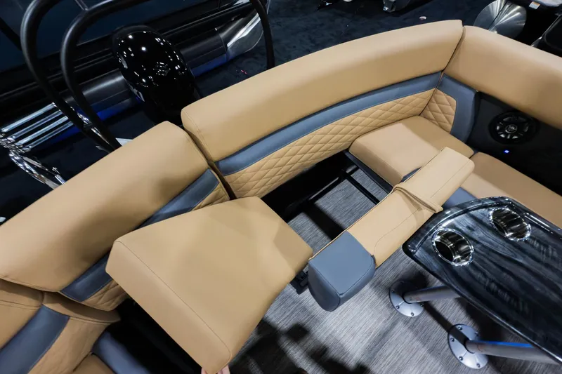 Slide: The Image of 2026 Godfrey Monaco 235 Ultra Lounge interior with tan and gray seating, cup holders, and modern design. - 19