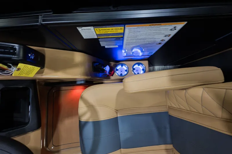 Slide: The Image of Interior of 2026 Godfrey Monaco 235 Ultra Lounge with illuminated cup holders and tan seating. - 26