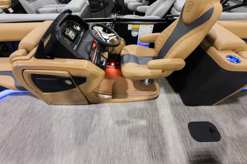 Slide: The Image of 2026 Godfrey Monaco 235 Ultra Lounge boat interior with luxurious captain's chair and modern dashboard. - 9
