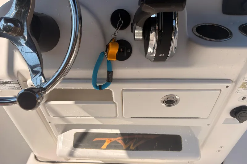 Slide: The Image of 2015 Tidewater 198 CC Adventure boat dashboard with steering wheel and controls. - 14