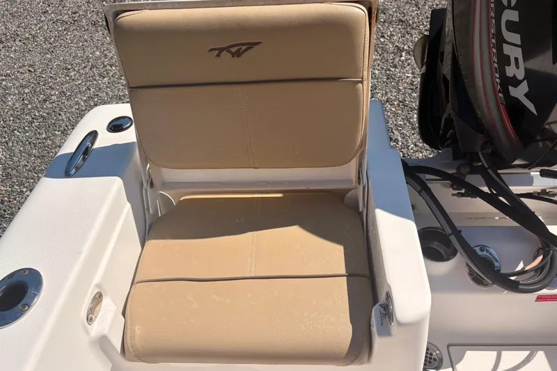 Slide: The Image of 2015 Tidewater 198 CC Adventure boat seat with beige upholstery and Mercury engine. - 15