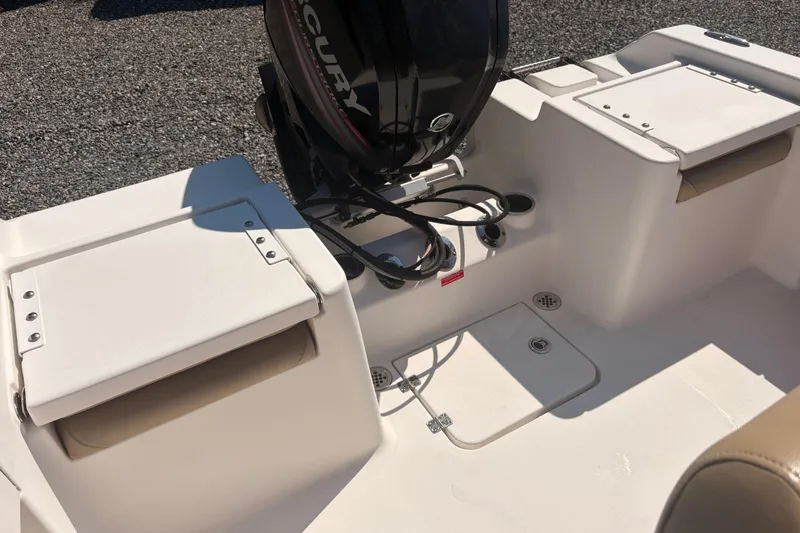 Slide: The Image of 2015 Tidewater 198 CC Adventure boat interior with Mercury engine, featuring seating and storage. - 16