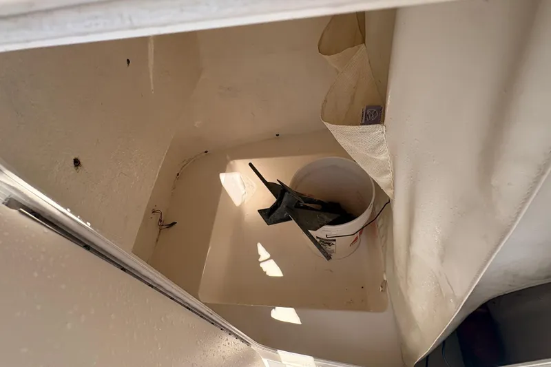 Slide: The Image of Storage compartment of 2015 Tidewater 198 CC Adventure boat with bucket and anchor. - 22