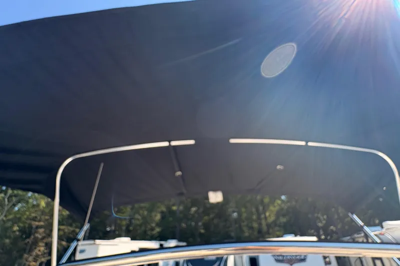 Slide: The Image of 2015 Tidewater 198 CC Adventure boat with sunshade under bright sunlight. - 23