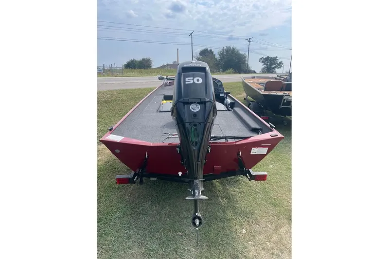 Slide: The Image of 2026 Lowe Skorpion 17 boat with 50 HP outboard motor, parked on grass. - 4