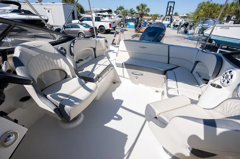 Slide: The Image of 2024 Stingray 211DC boat interior with plush seating and modern design. - 10