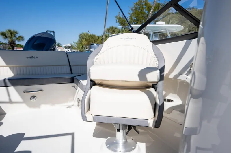 Slide: The Image of 2024 Stingray 211DC boat interior with plush seating and modern design. - 11