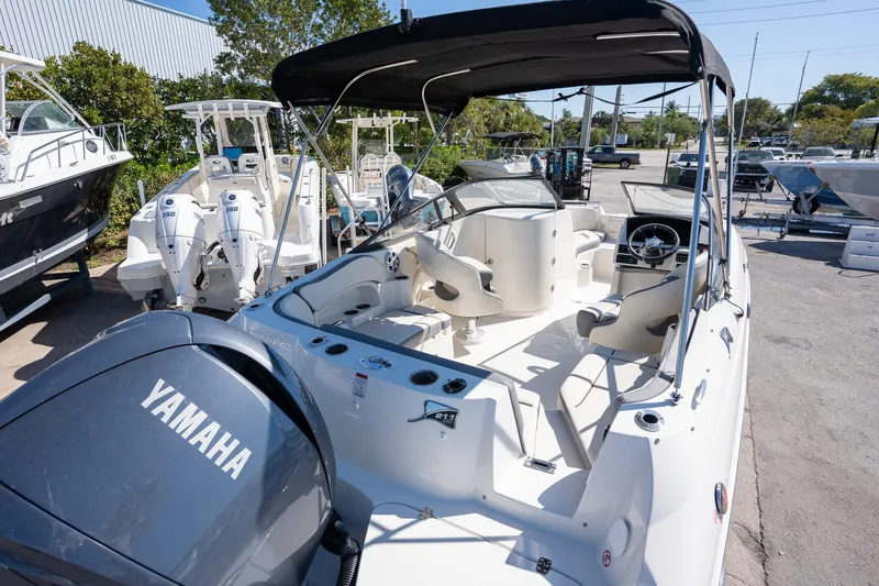 Slide: The Image of 2024 Stingray 211DC boat with Yamaha engine, featuring spacious seating and sleek design. - 12